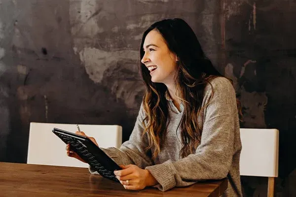 Woman working on a tablet in a meeting