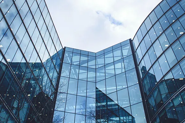 Glass office building with sky in background