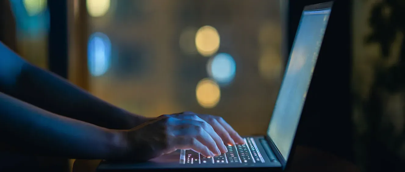 Person typing on laptop