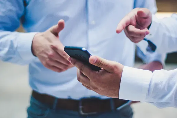Man pointing at mobile phone